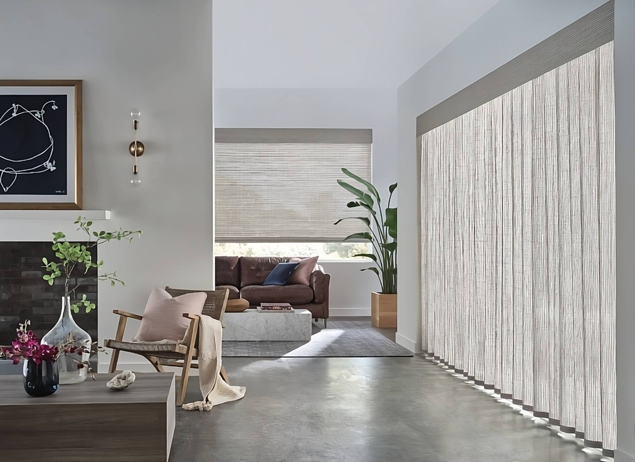 Hunter Douglas Provenance® Woven Wood Shades on expansive windows in a cozy living room at Delux Drapery & Shade Co. near Ann Arbor,(MI)