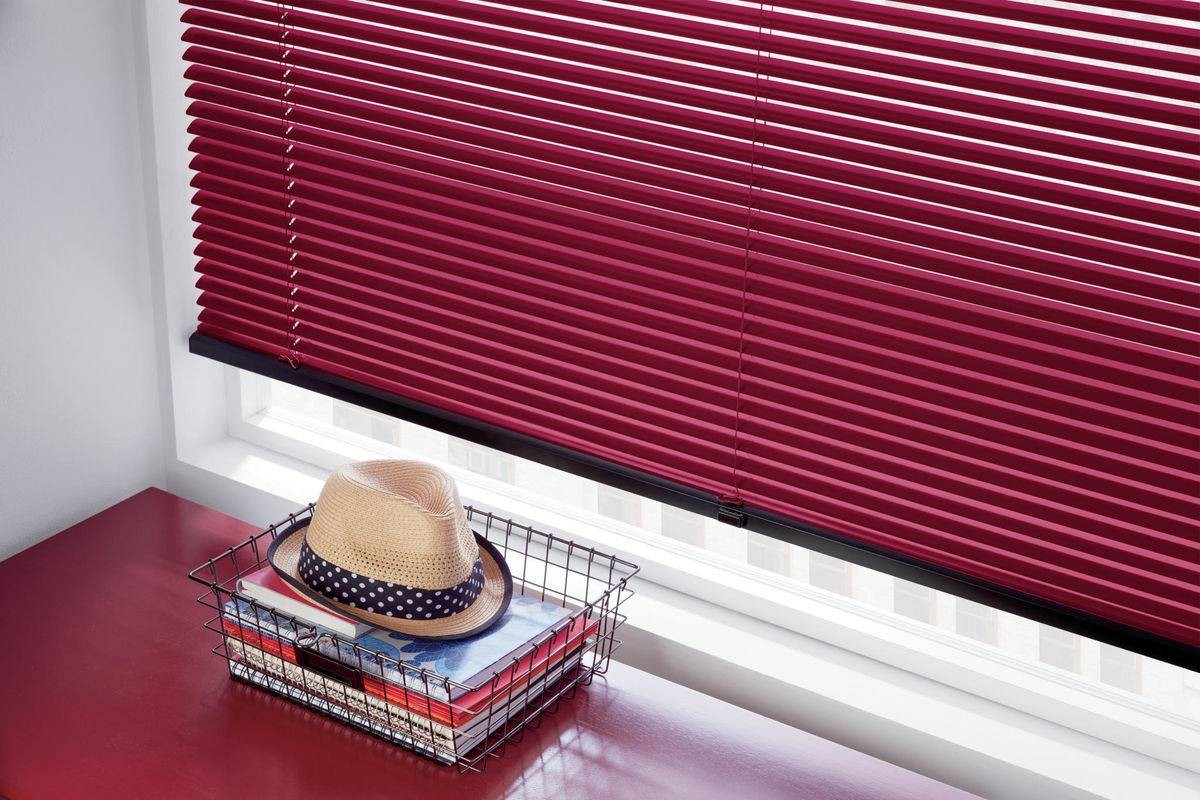 Brightly colored Hunter Douglas Modern Precious Metals® Mini Blinds decorating a window behind an end table near Ann Arbor, MI