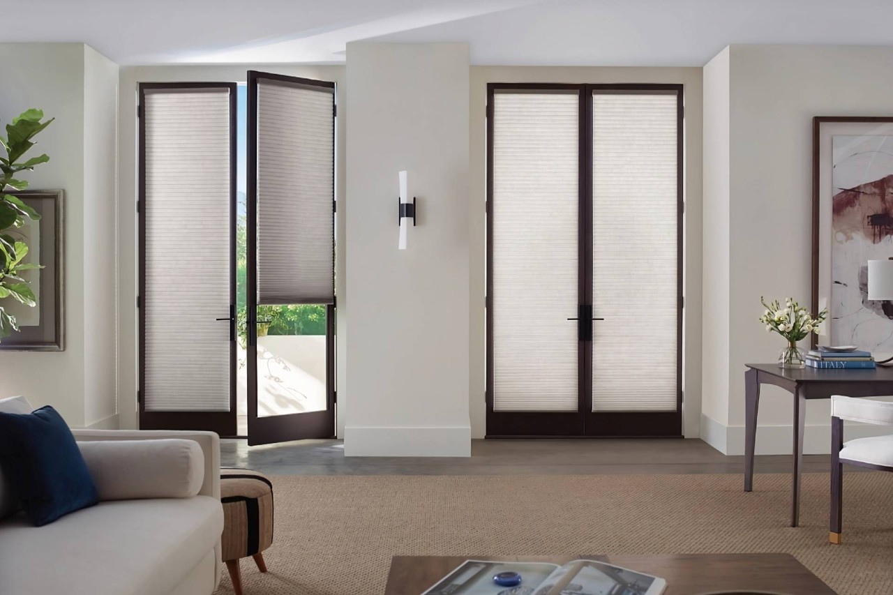 Hunter Douglas Duette® Cellular Shades on two sets of French doors in a traditional living room near Ann Arbor, MI
